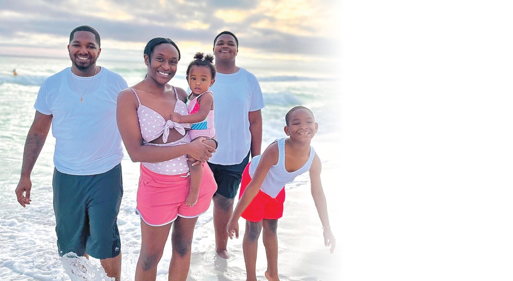 Family smiling on the beach