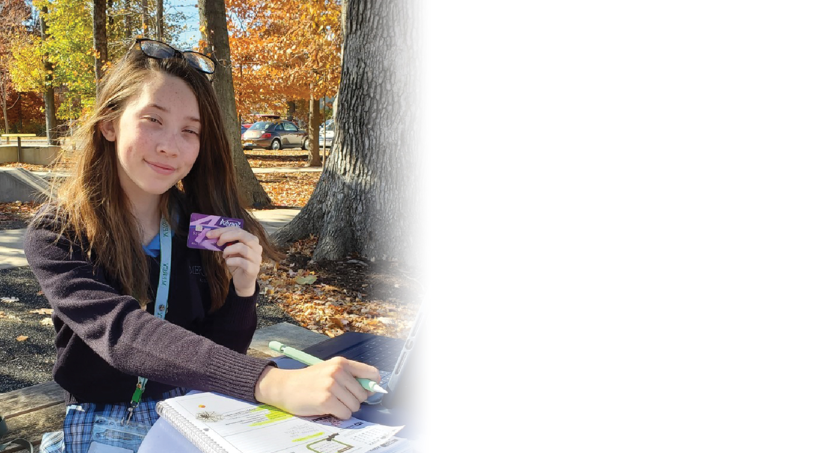 Young girl smiling with debit card