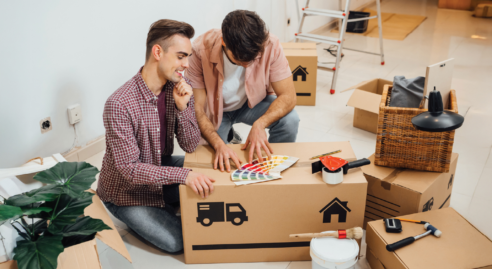 Image of young male couple choosing paint swatches and planning project.